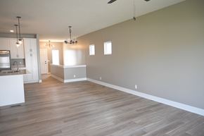 Omaha townhouse for rent - A large empty room with wooden floors and white walls.