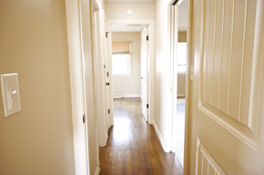 Omaha apartment for rent - A long hallway with doors on both sides.