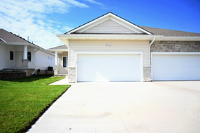 Omaha townhouse for rent - A two-car garage is attached to a house.