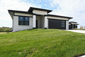 Gretna apartment for rent - A modern house with a black garage door.