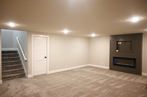 Gretna apartment for rent - A spacious living room with a fireplace and a staircase.