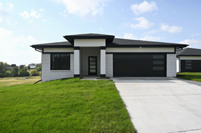 Gretna apartment for rent - A modern house with a black roof and a white exterior.