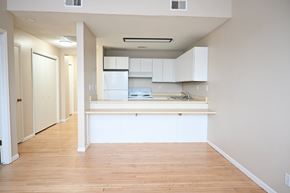 Omaha apartment for rent - A kitchen with white cabinets and a wooden floor.