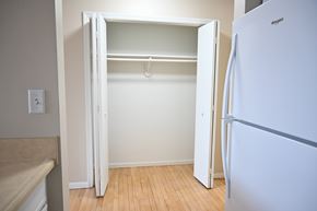 Omaha apartment for rent - A white refrigerator is in a kitchen with a white door.