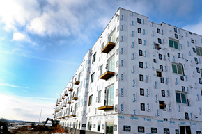 Lincoln apartment for rent - A building under construction with a blue sky in the background.