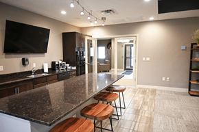 Kearney apartment for rent - A kitchen with granite countertops and bar stools.