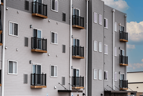 Alliance apartment for rent - A building with balconies and windows.