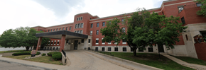 Grand Island apartment for rent - A red brick building with a covered walkway.