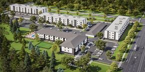 Lincoln apartment for rent - A large, modern building complex with a parking lot in front.