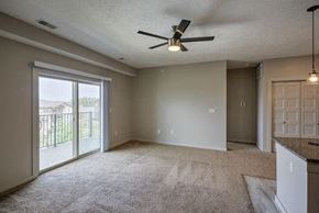 Gretna apartment for rent - A spacious room with a ceiling fan and sliding glass doors.