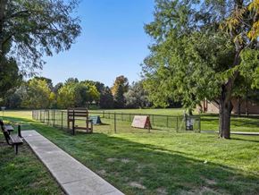 Kearney apartment for rent - A park with a walking path, benches, and a playground.