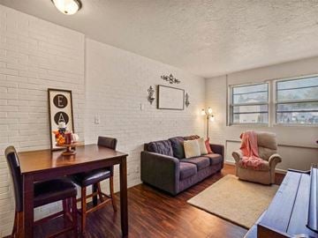 Kearney apartment for rent - A living room with a grey couch and a wooden table.
