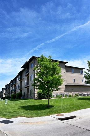 Kearney apartment for rent - A tree is in front of a building.