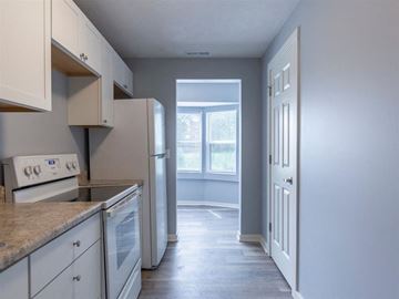 Omaha apartment for rent - A kitchen with white cabinets and appliances.