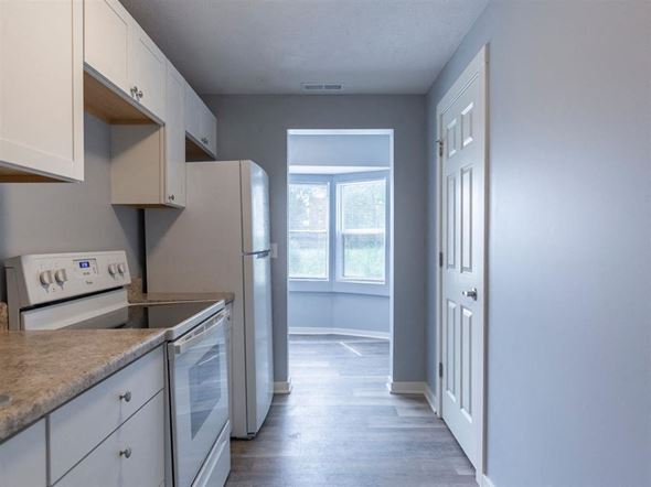 Omaha apartment for rent - A kitchen with white cabinets and appliances.