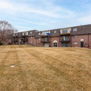 Omaha apartment for rent - A grassy field in front of apartment buildings.