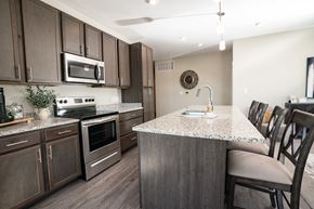 Lincoln apartment for rent - A kitchen with brown cabinets and a granite countertop.
