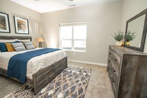 Lincoln apartment for rent - A bedroom with a bed, dresser, and window.