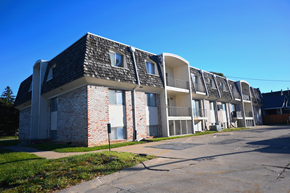 Omaha apartment for rent - Exterior view of a multi story apartment building with brick and siding at Northbrook Apartments