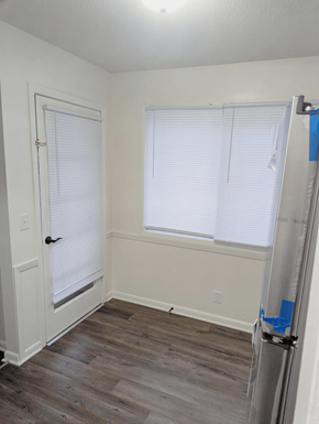 Omaha apartment for rent - Dining area with wood style flooring window and door at Northbrook Apartments