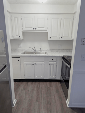 Omaha apartment for rent - Kitchen with white cabinets sink and upper storage at Northbrook Apartments
