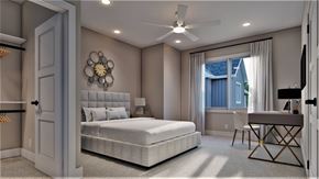 Omaha apartment for rent - A bedroom with a large bed, a ceiling fan, and a window with curtains.