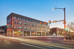 Council Bluffs apartment for rent - A long exposure shot of a street with a red traffic light and a building in the background.