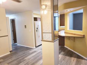 Grand Island apartment for rent - A room with a yellow wall and a white fridge.