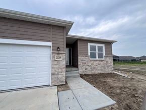 Eklhorn apartment for rent - A house with a brown siding and a white garage door is numbered 21209.