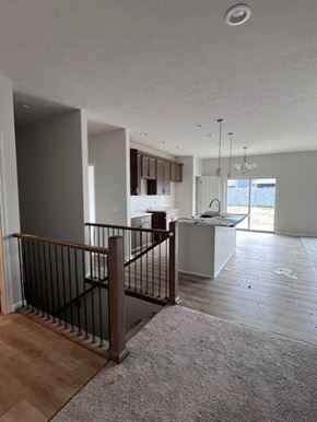 Eklhorn apartment for rent - A room with a wooden floor and a white ceiling with a light fixture.