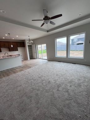 Eklhorn apartment for rent - A spacious room with a ceiling fan and a kitchen area.