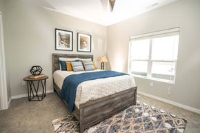 North Platte apartment for rent - A bedroom with a large bed and a window.
