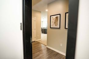 North Platte apartment for rent - A hallway with a brown rug and two pictures on the wall.