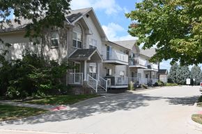 Omaha apartment for rent - A row of houses with a tree in front of them.