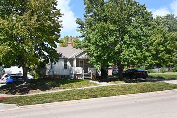 Omaha apartment for rent - A car is parked on the street in front of a house.
