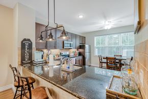 Huntsville apartment for rent - the kitchen and dining area of a house with a granite counter top