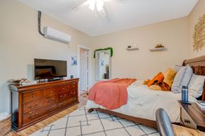 Huntsville apartment for rent - a bedroom with a bed and a dresser and a tv