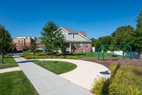 Countryside apartment for rent - A playground with a slide and a house in the background.