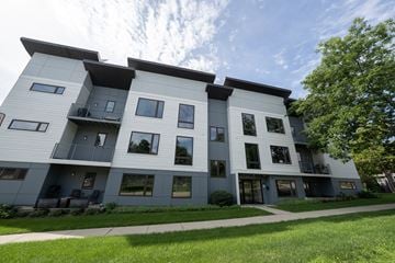 Downers Grove apartment for rent - A modern apartment building with balconies and large windows.