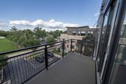 Barrington apartment for rent - A balcony with a black railing and a parking lot in the background.