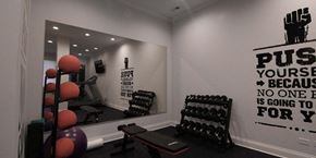 Chicago apartment for rent - a gym with weights and a mirror on the wall  at Tripp 4321, Chicago, IL