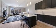Clarendon Hills apartment for rent - a kitchen with an island and a living room at Clarendon Hills 229, Clarendon, IL