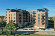 Highwood apartment for rent - a brick apartment building with balconies and a sidewalk