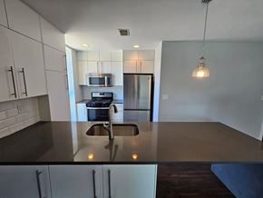 Chicago apartment for rent - an empty kitchen with a counter top and a sink