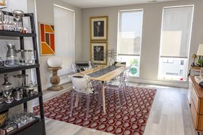Chicago apartment for rent - a dining room with a wooden table and chairs and a red rug