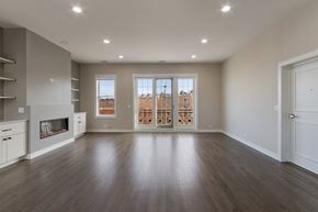 Chicago apartment for rent - an empty living room with a fireplace and a window