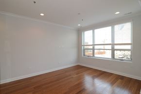 Chicago apartment for rent - a living room with wood floors and a large window