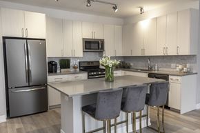 Chicago apartment for rent - a kitchen with stainless steel appliances and white cabinets