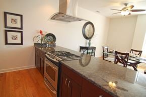 Chicago apartment for rent - a kitchen with a granite counter top and a dining room with a table and chairs