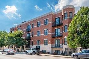 Chicago apartment for rent - A red brick building with black railings on the balconies.
